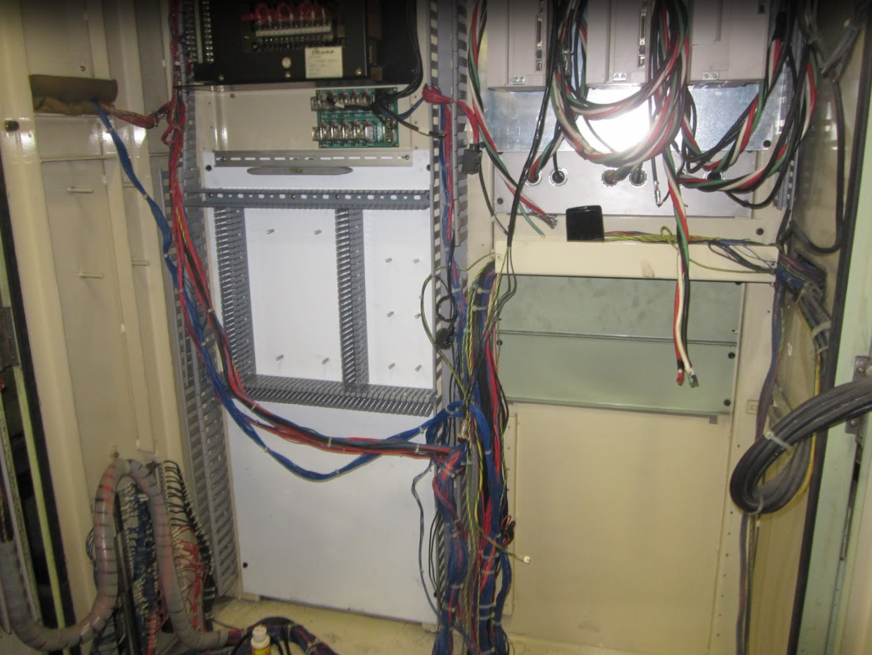 CNC control cabinet subplate stripped of old components. AC servos installed 